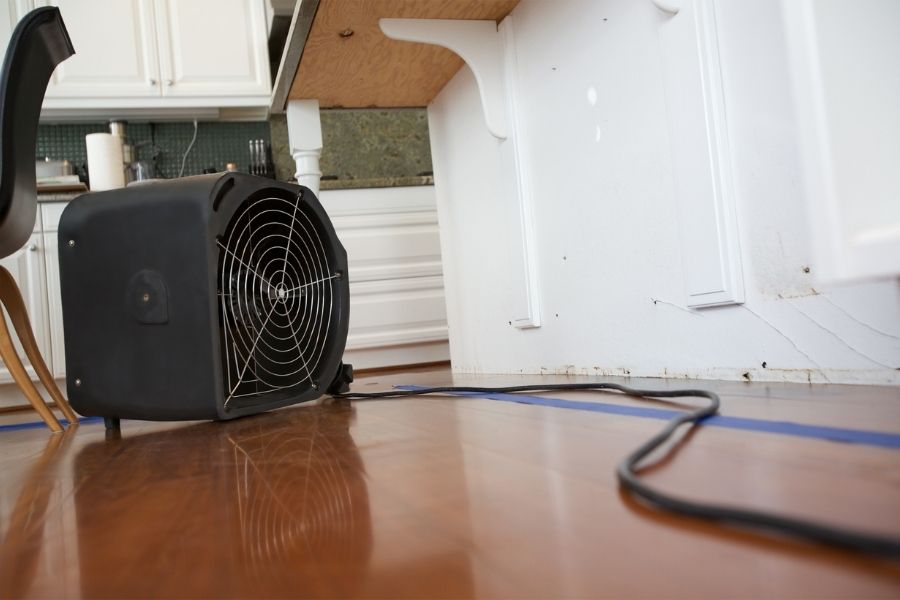 Fan and dehumidifier running in water damaged room