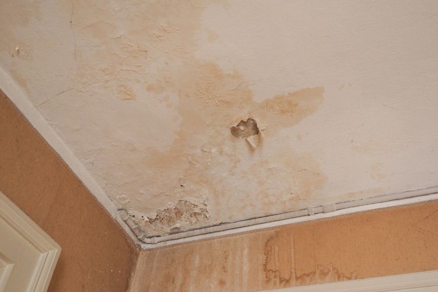 Water damage discoloration on walls and ceiling