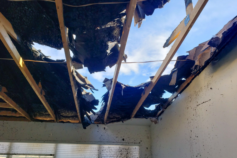 Roof damage from fire showing holes and structural compromise