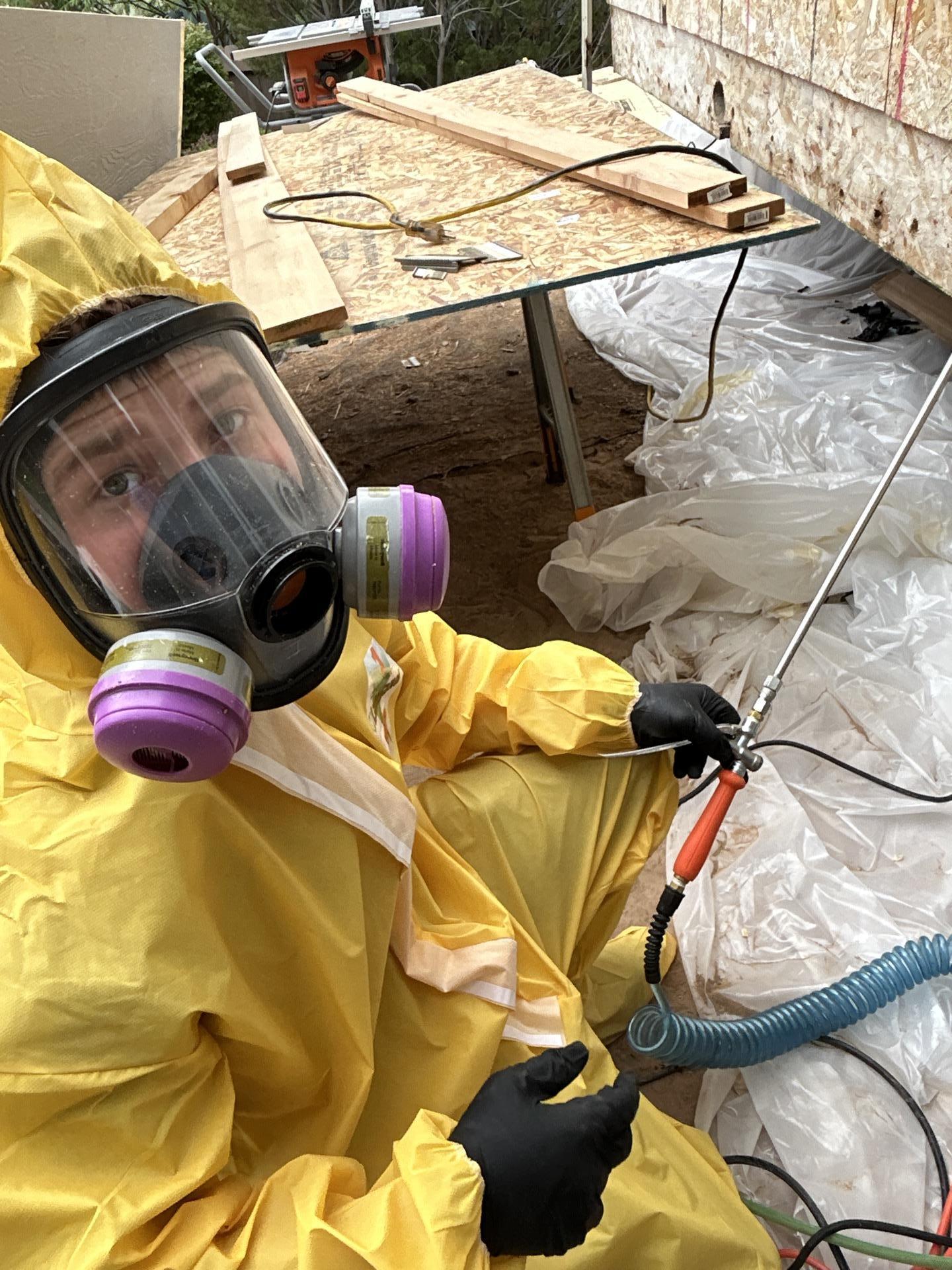 Technician in full PPE during remediation