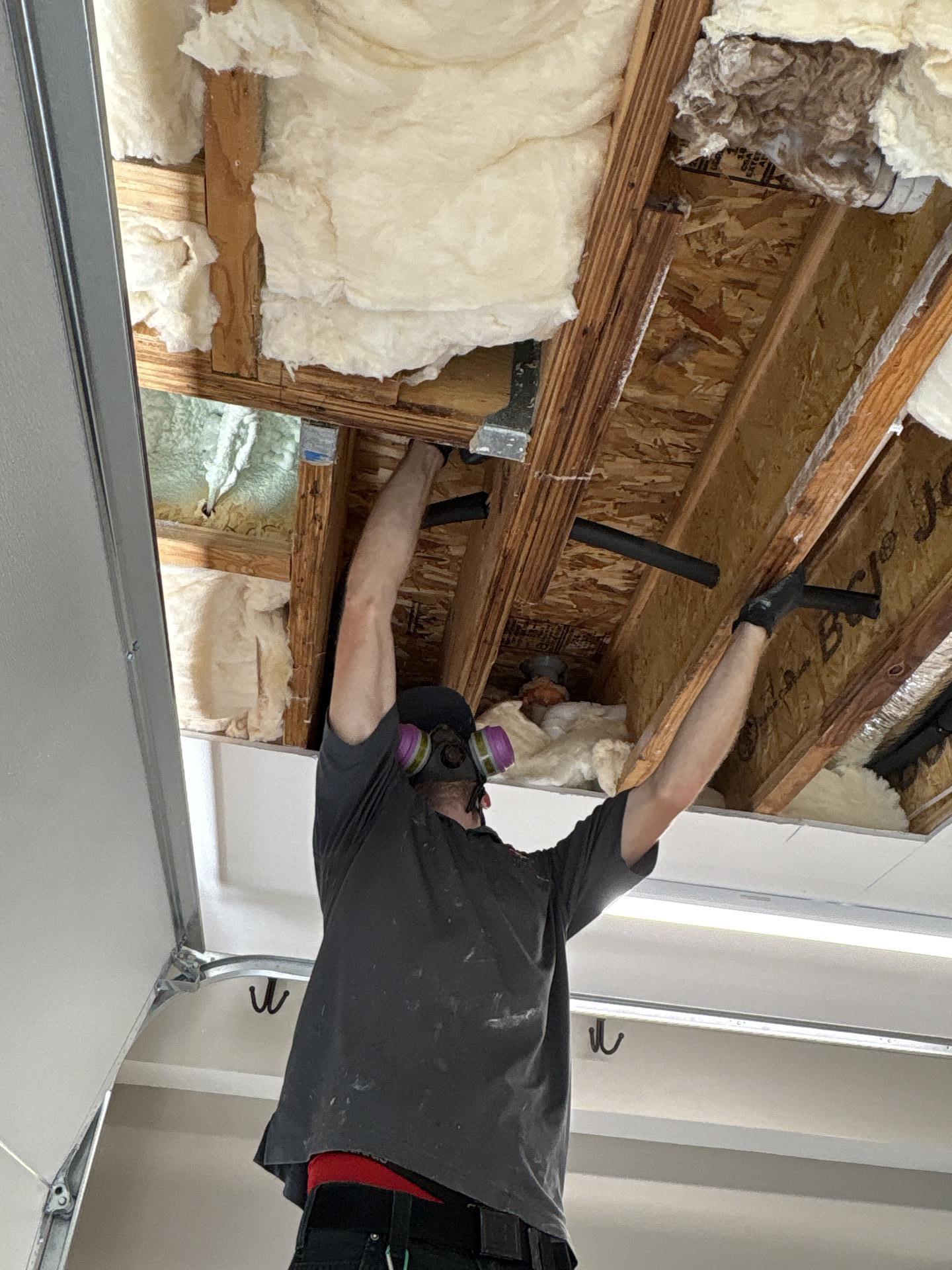 Exploratory opening revealing water damage extent