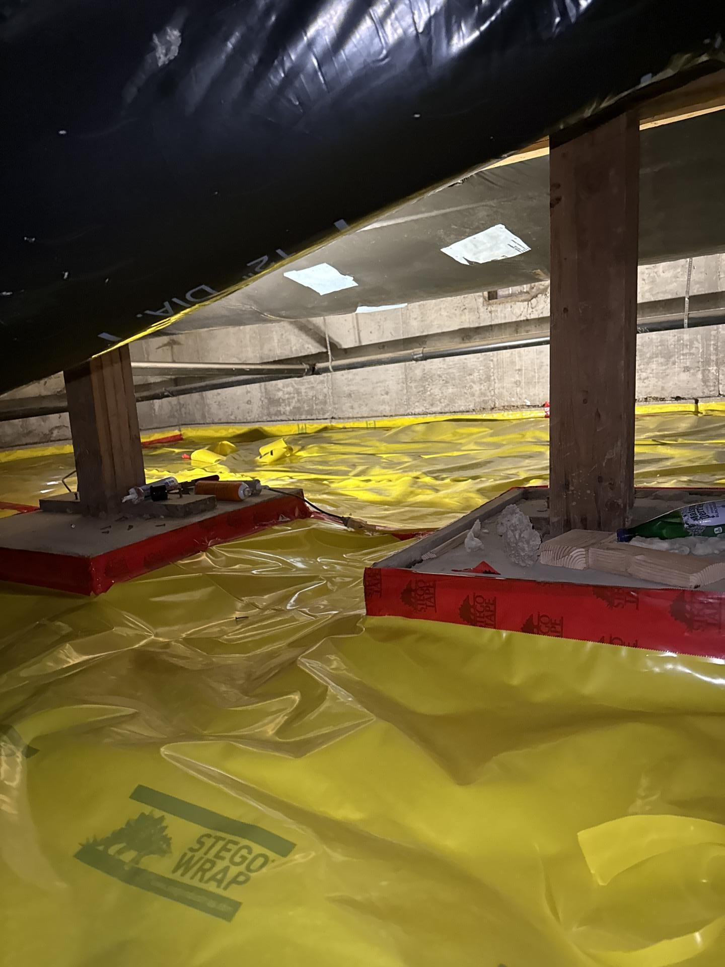New vapor barrier installation in crawlspace