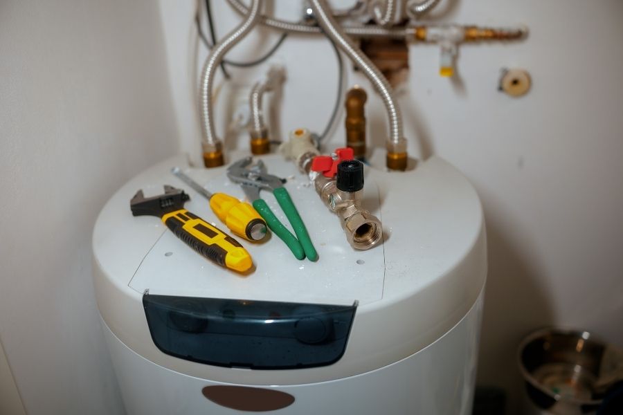 Professional technician inspecting damaged water heater