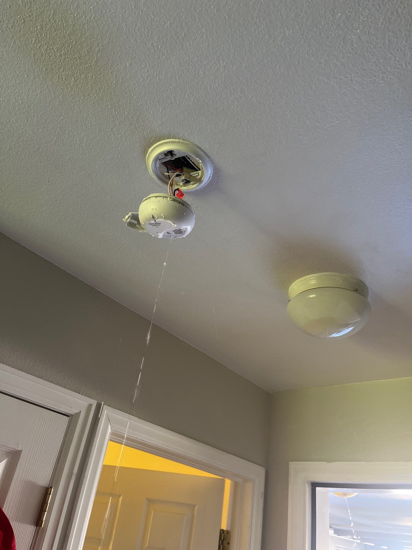 Water damage visible on ceiling drywall