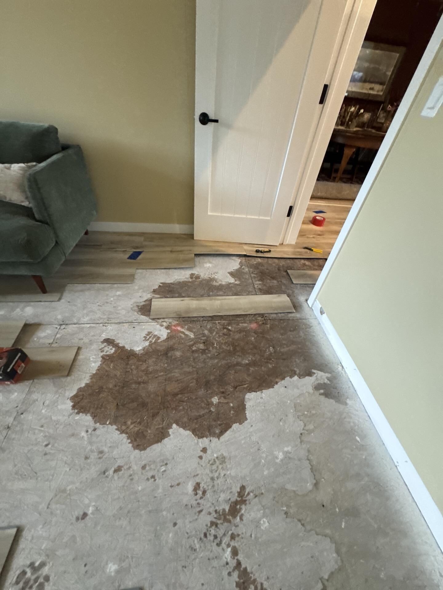 Bedroom wall with removed baseboards and cavity opening for directed airflow during water damage drying