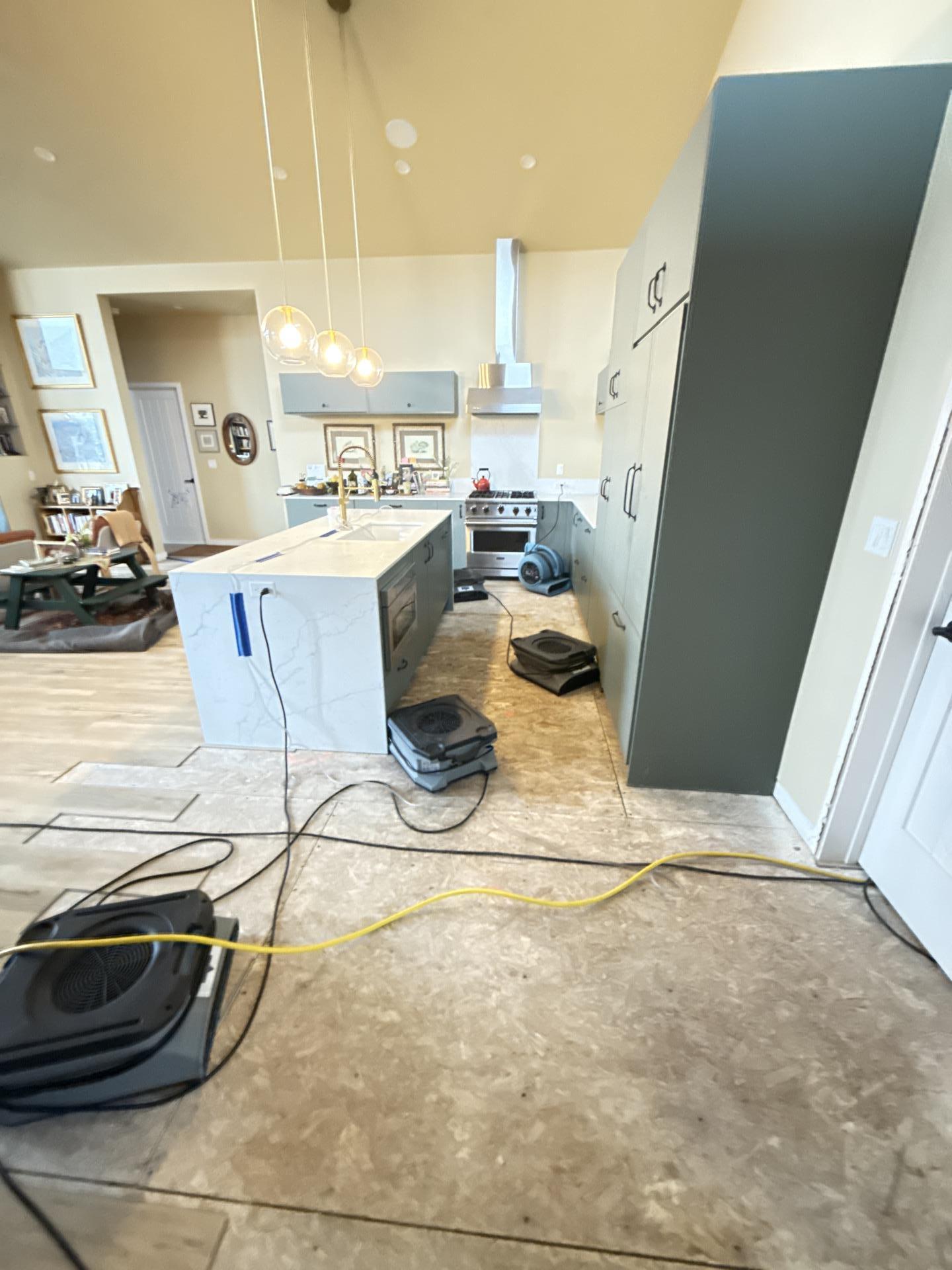 Kitchen base cabinets with swelling and deformation from water saturation along the bottom edges