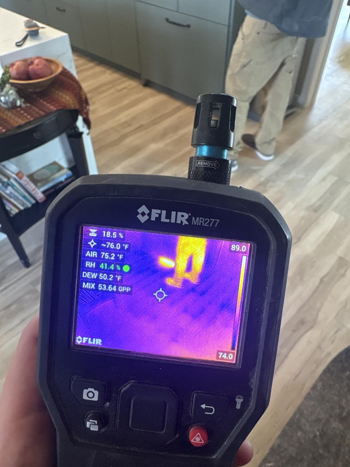 Thermal imaging scan revealing hidden moisture in kitchen flooring and walls after refrigerator supply line leak in Glenwood Springs