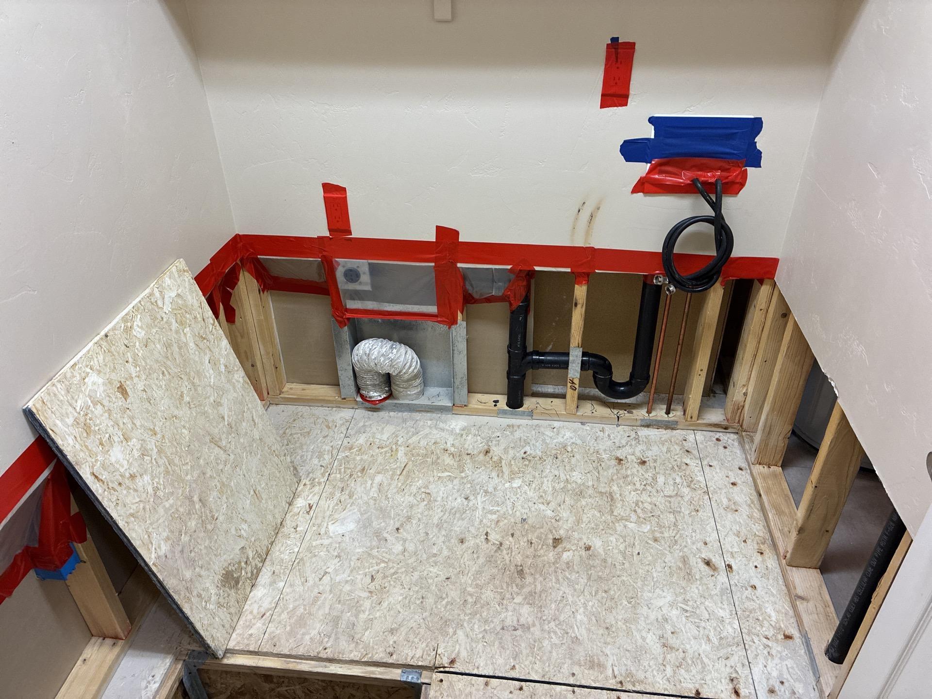 Laundry room after mold removal with exposed clean framing ready for treatment