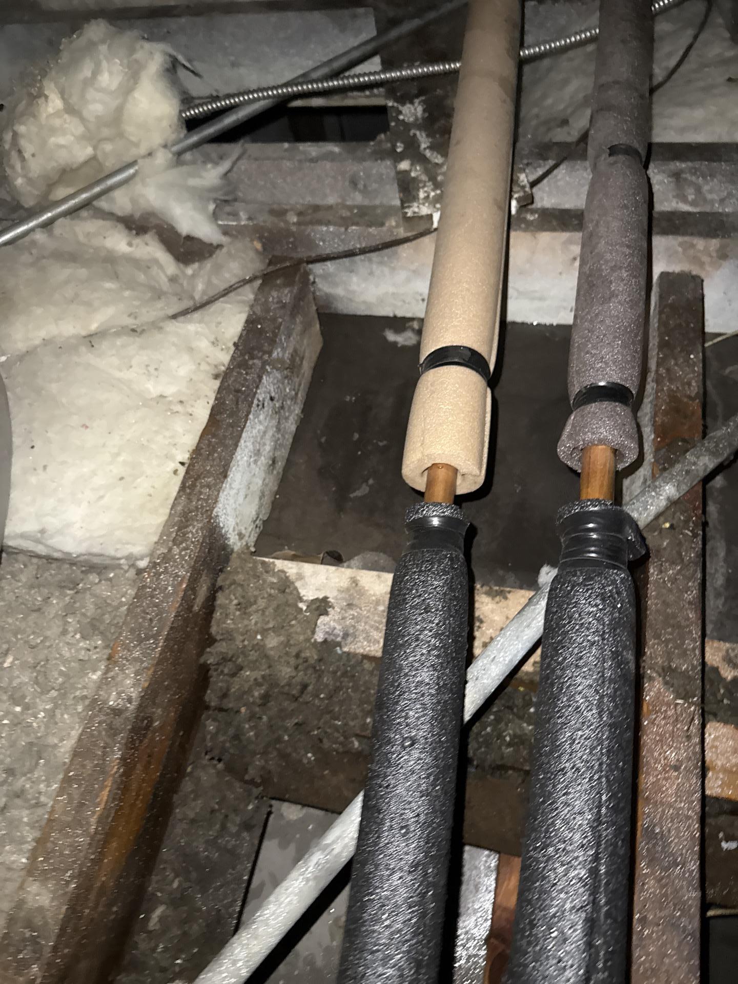 Heavily saturated attic insulation removed during water damage restoration in rear storage area