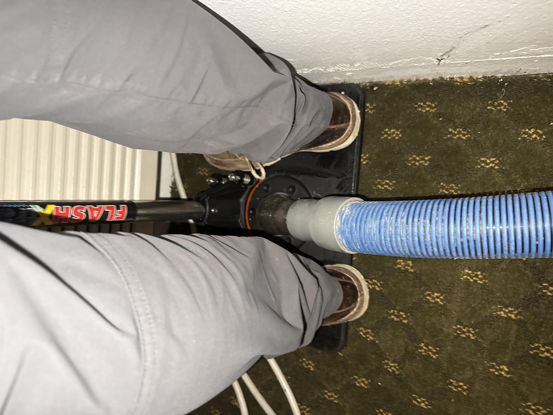 Weighted assist extraction system pulling water from saturated carpet and pad in Unit 101