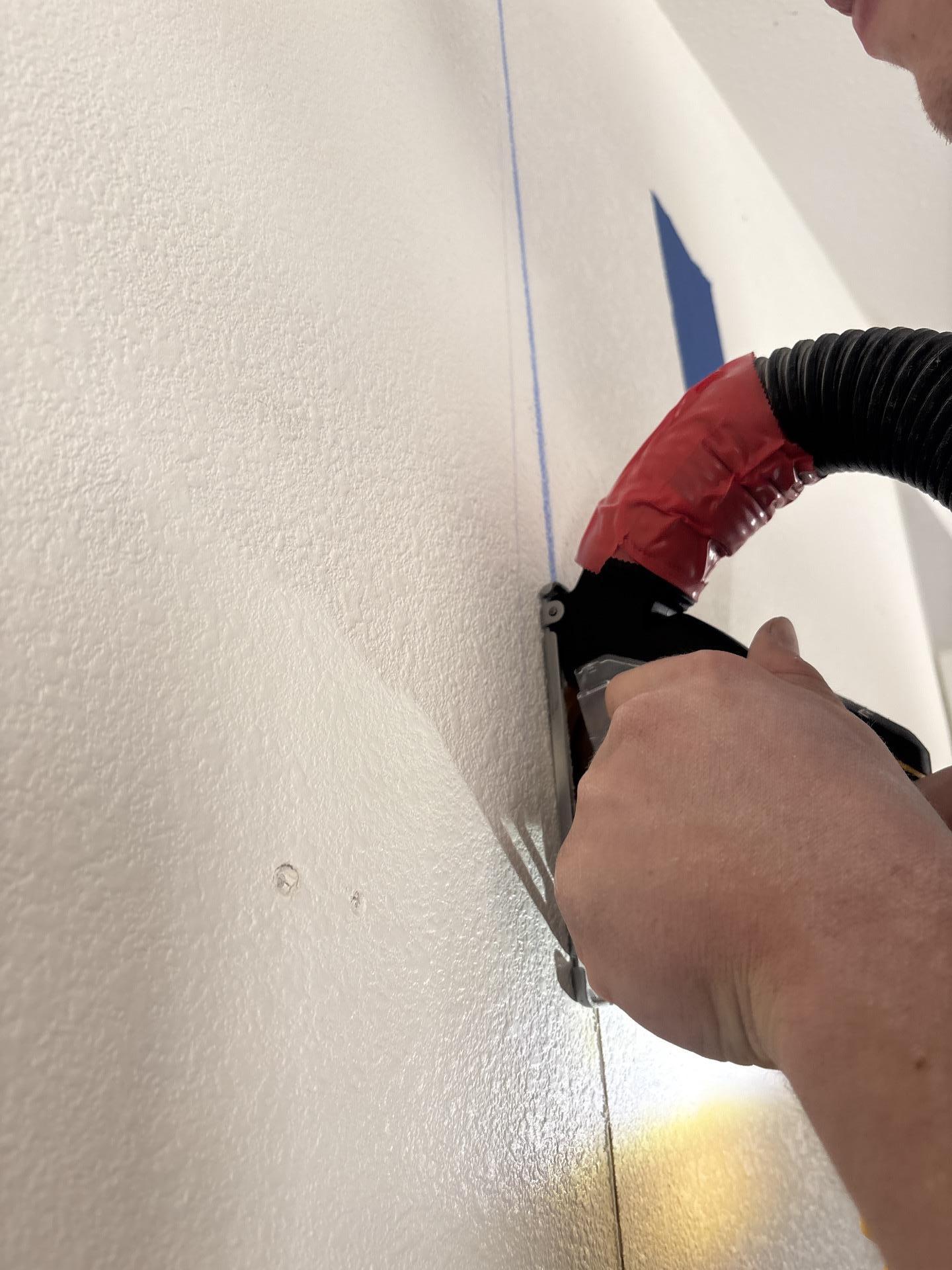 Flood cuts in hallway drywall after affected materials removed to expose structure for drying