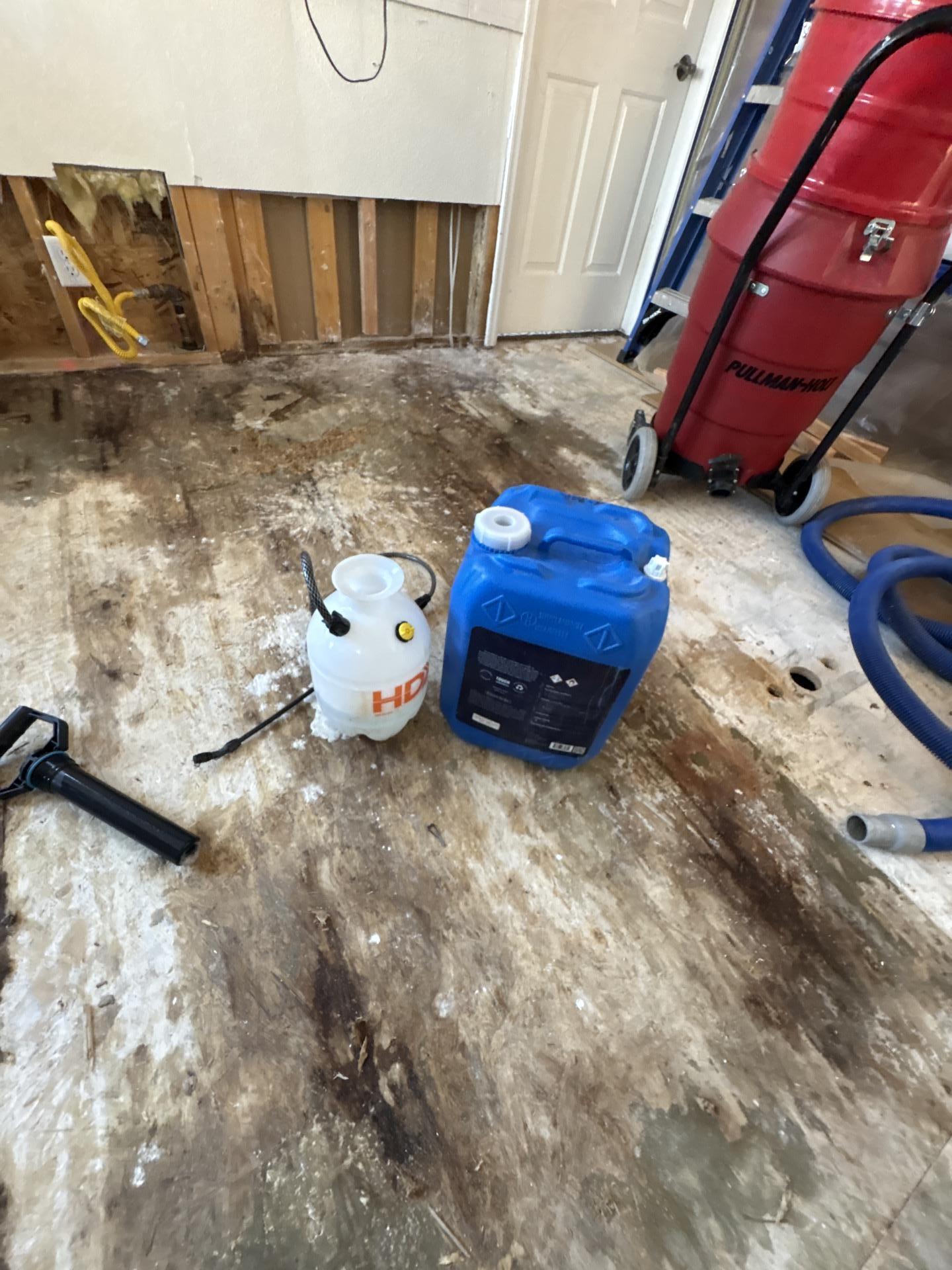 Exposed OSB subfloor treated during kitchen water damage mitigation