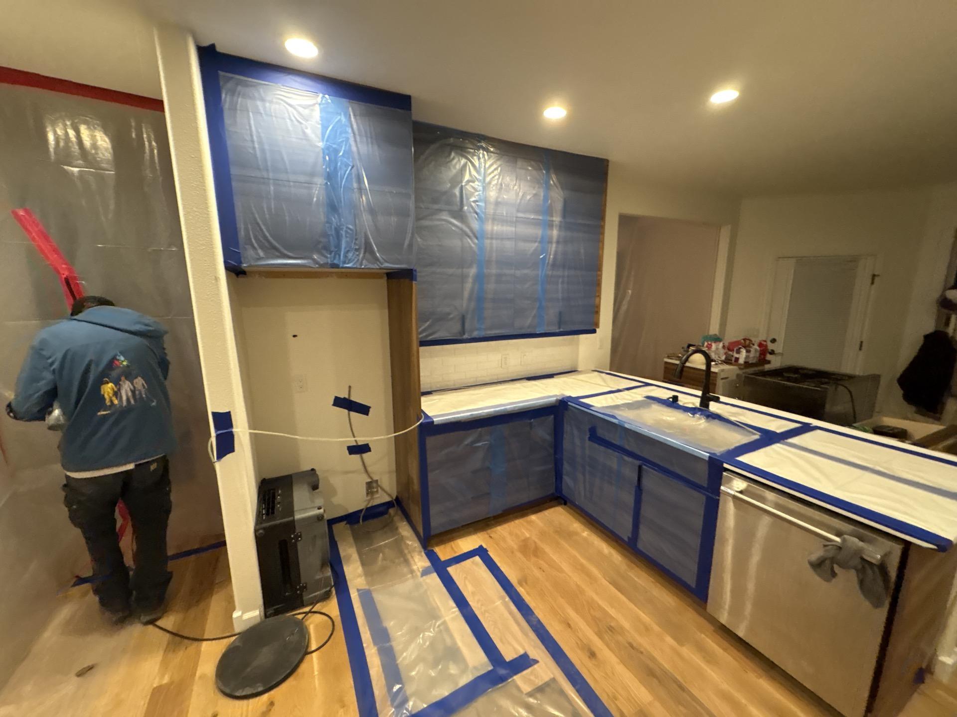 Drying equipment running in the kitchen during monitored structural drying