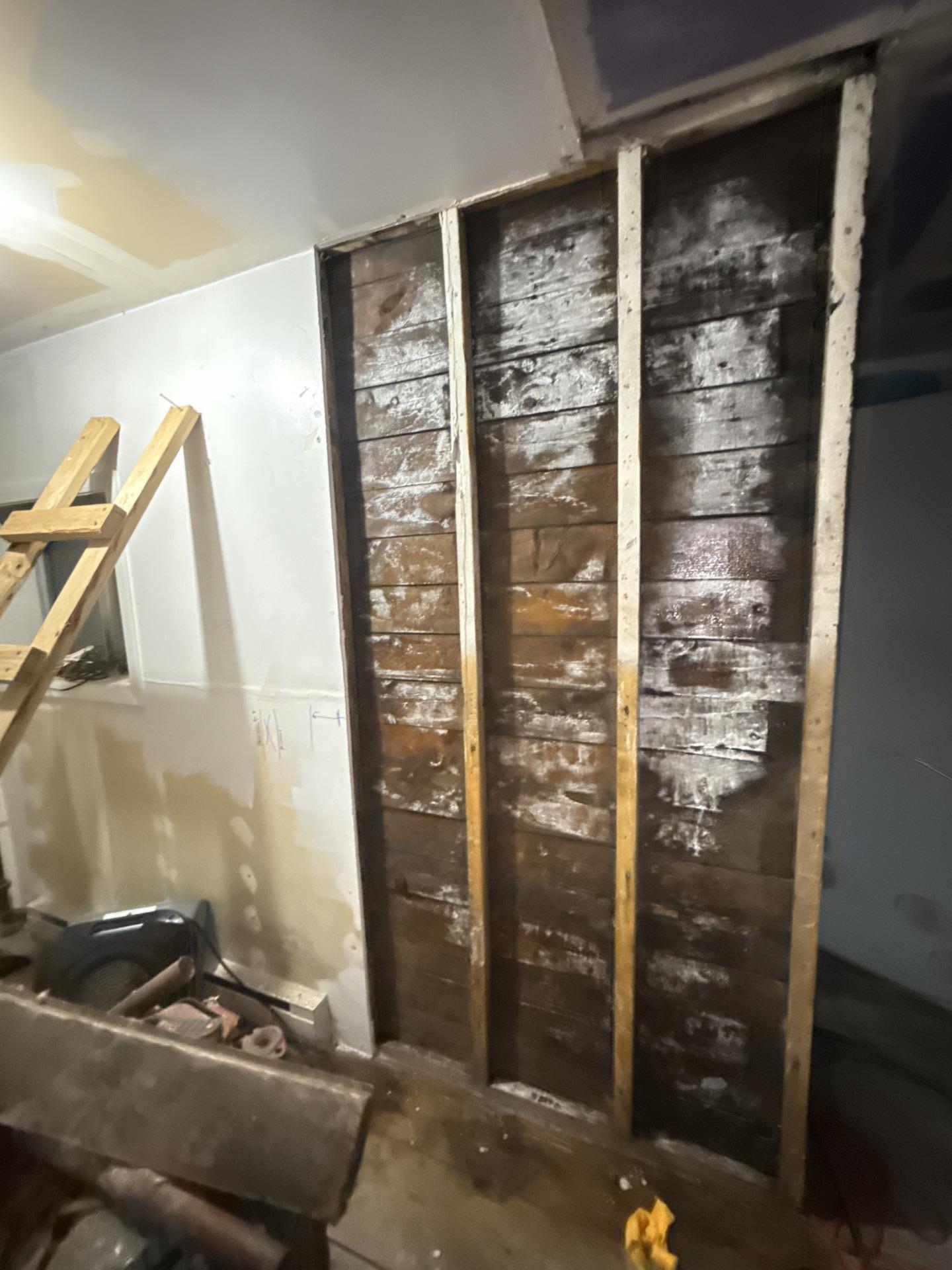Water damage cleanup in rear storage room after standing water pumped from crawlspace
