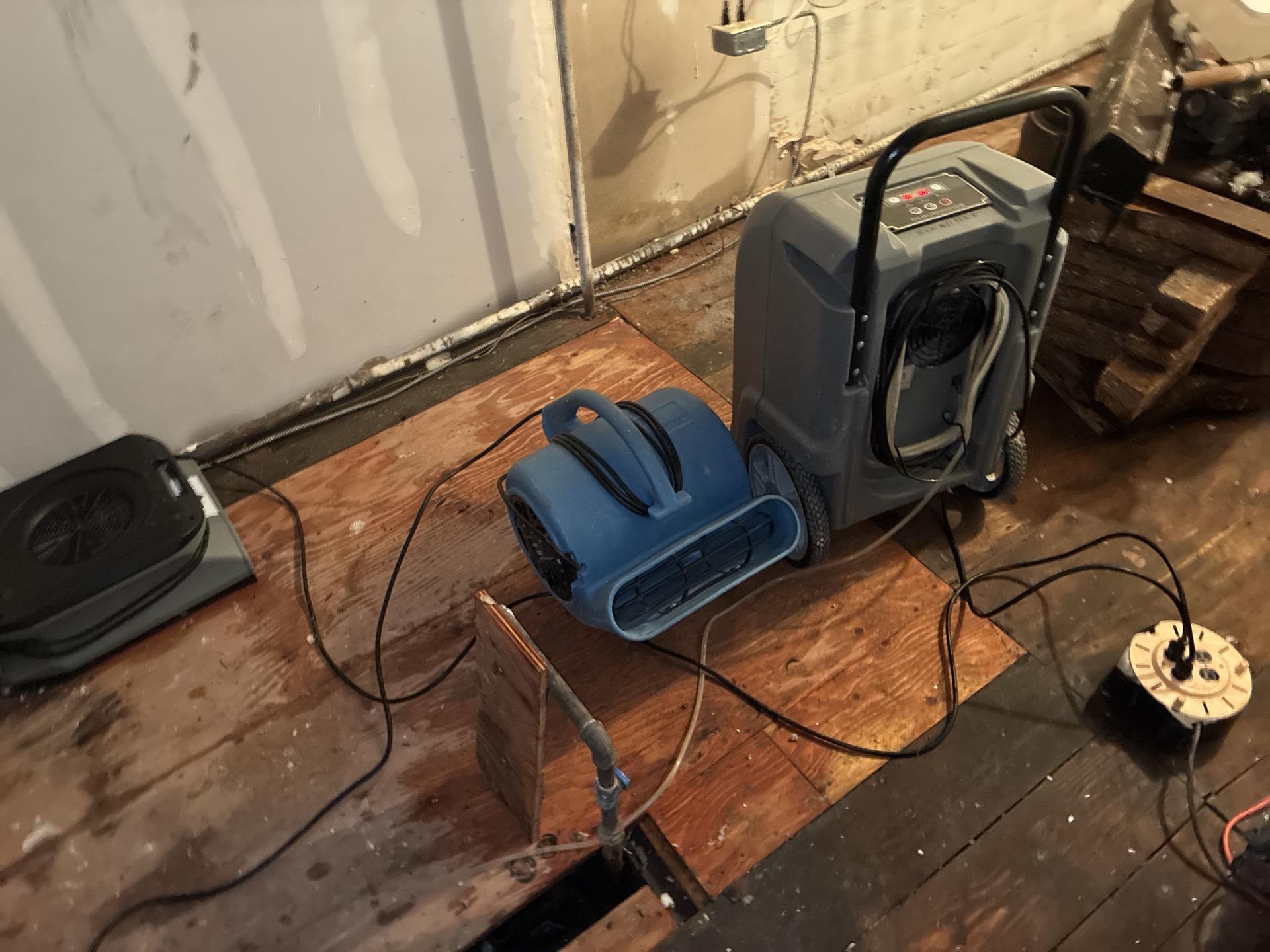 Storage area after standing water removed and saturated insulation taken out during restoration