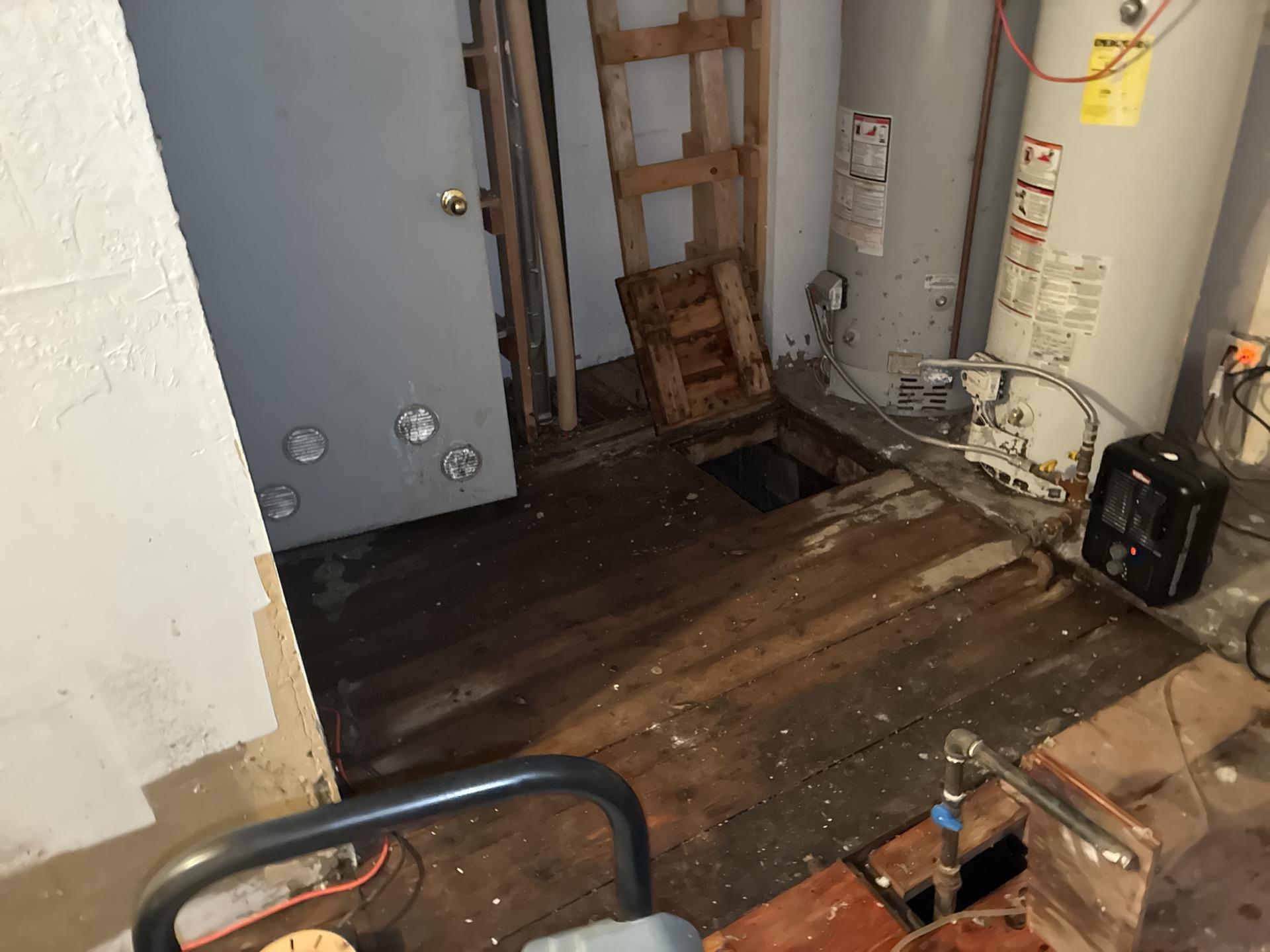 Rear storage room showing extent of water damage before cleanup and equipment deployment