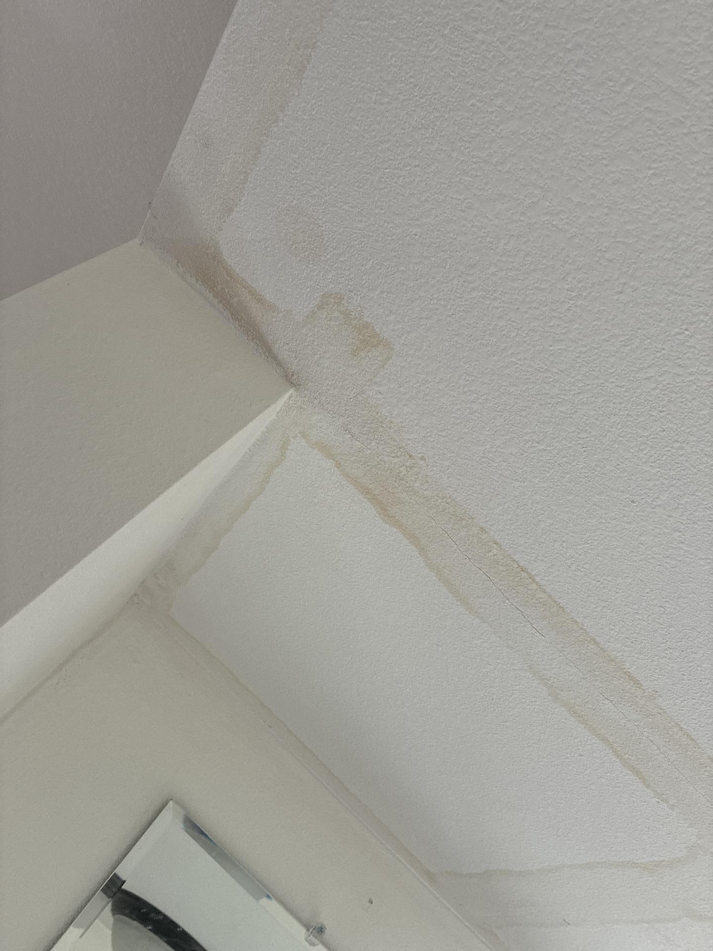 Water stains on drywall surfaces indicating moisture migration through wall assemblies