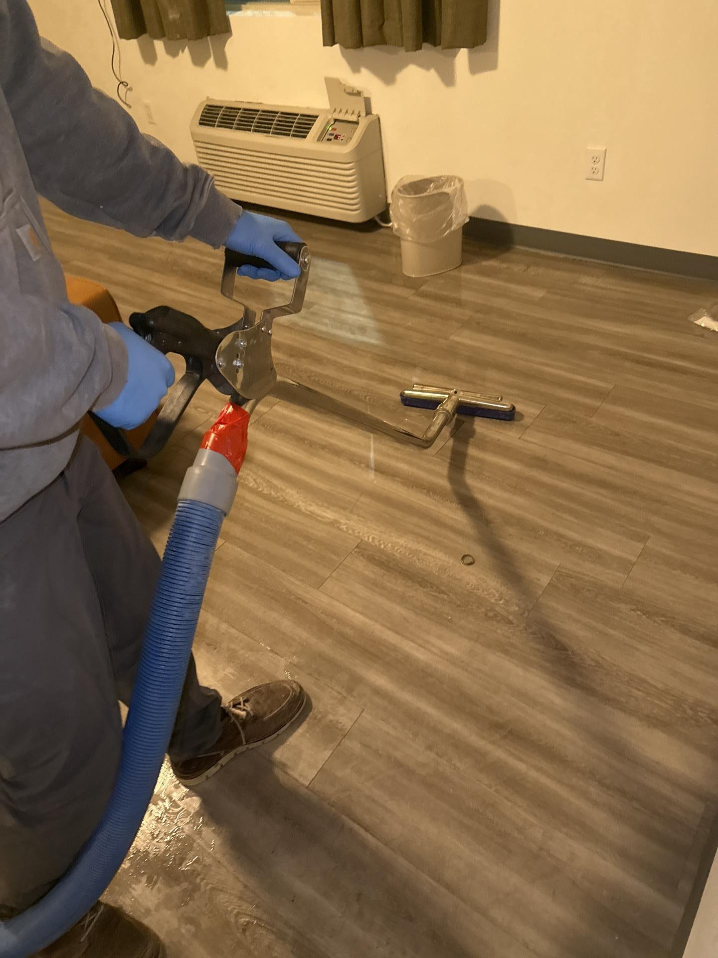 Hard-surface water extractor removing standing water from flooring during emergency water mitigation