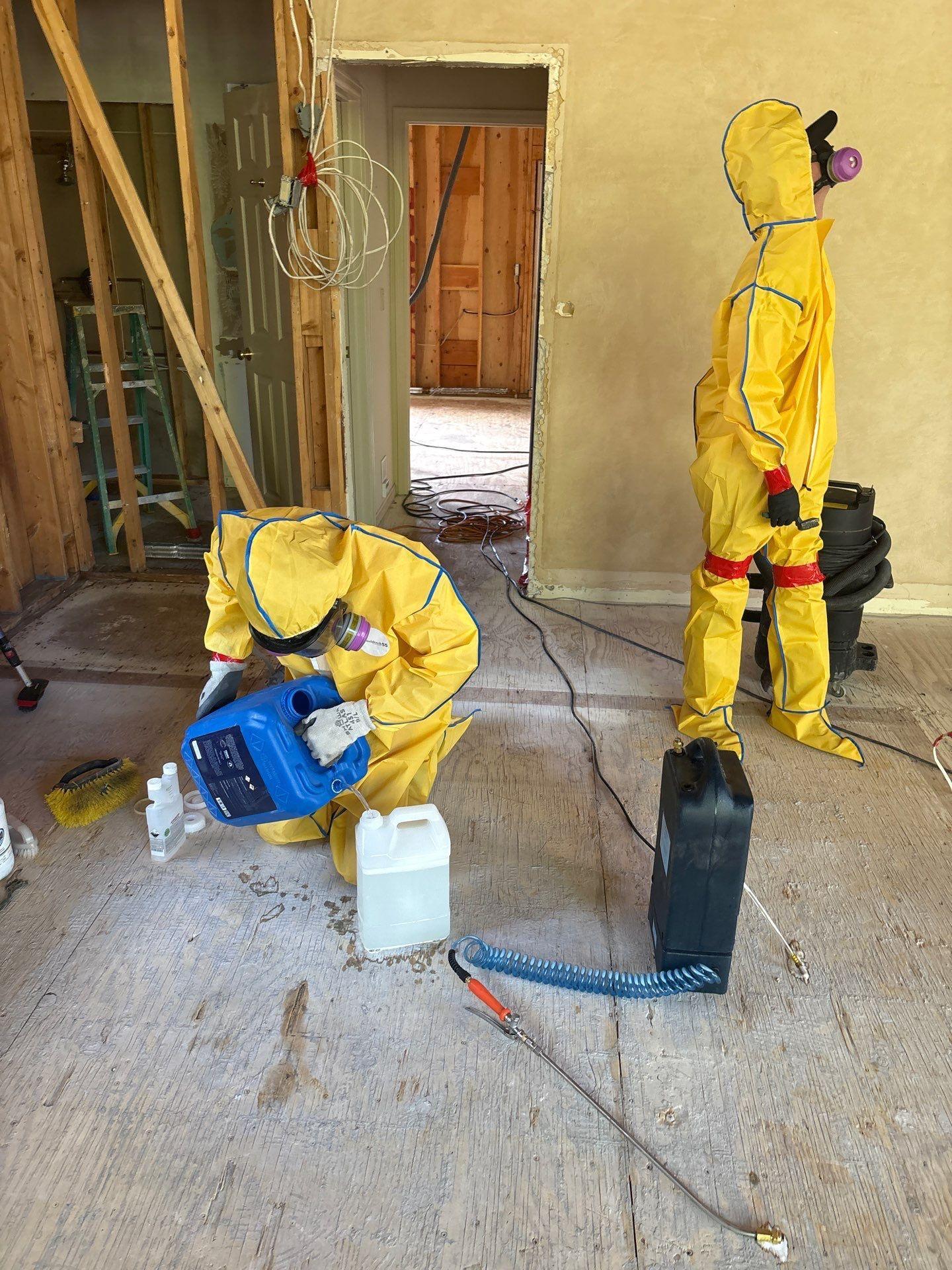 Technician in personal protective equipment working inside the containment area