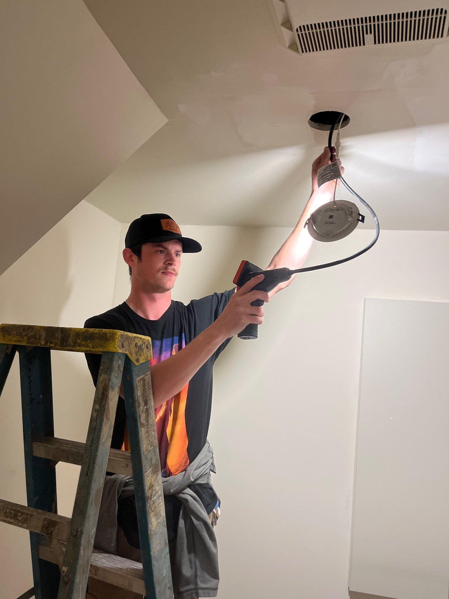 RemediH2O technician inspecting the stairway ceiling for mold and moisture damage