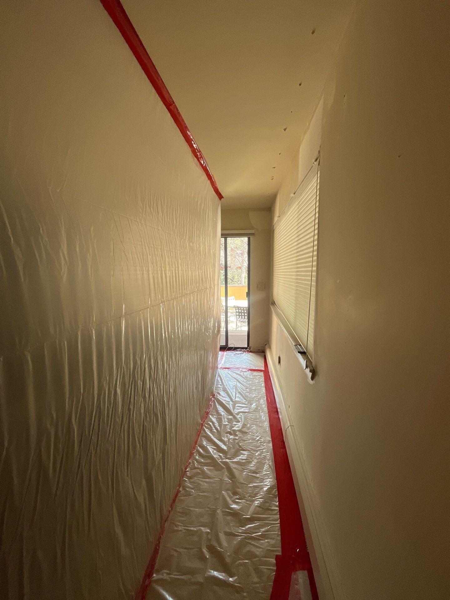 Plastic containment barrier set up during mold remediation in the Aspen home