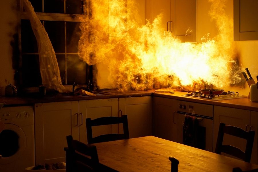 Kitchen grease fire with flames rising from a stovetop