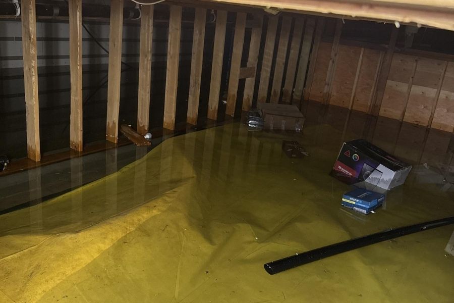 Standing water pooled in a home crawlspace after a leak