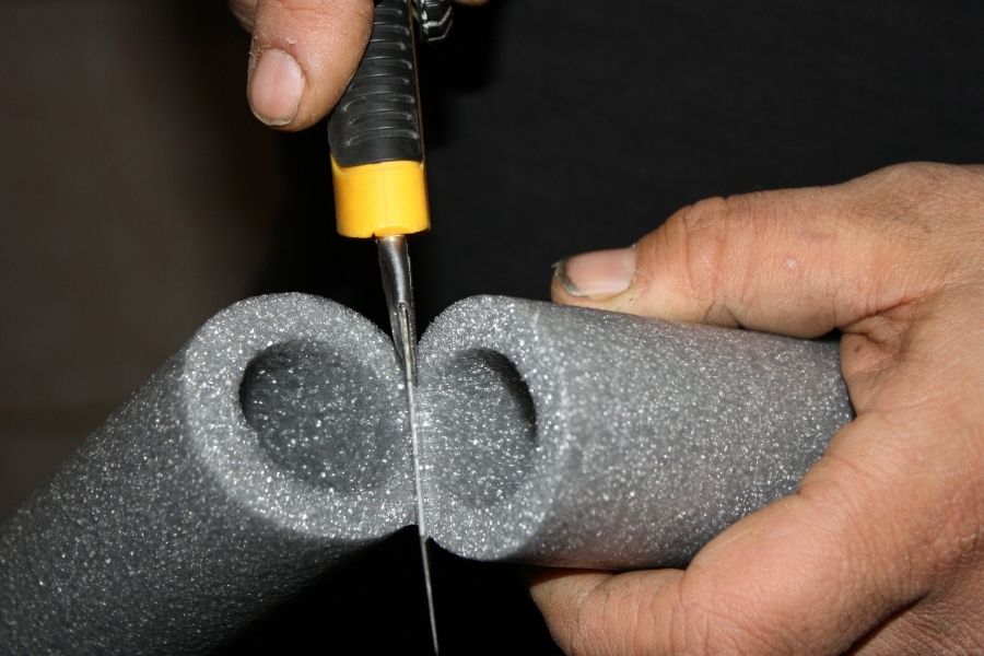 Foam insulation sleeves installed on exposed pipes to prevent winter freezing