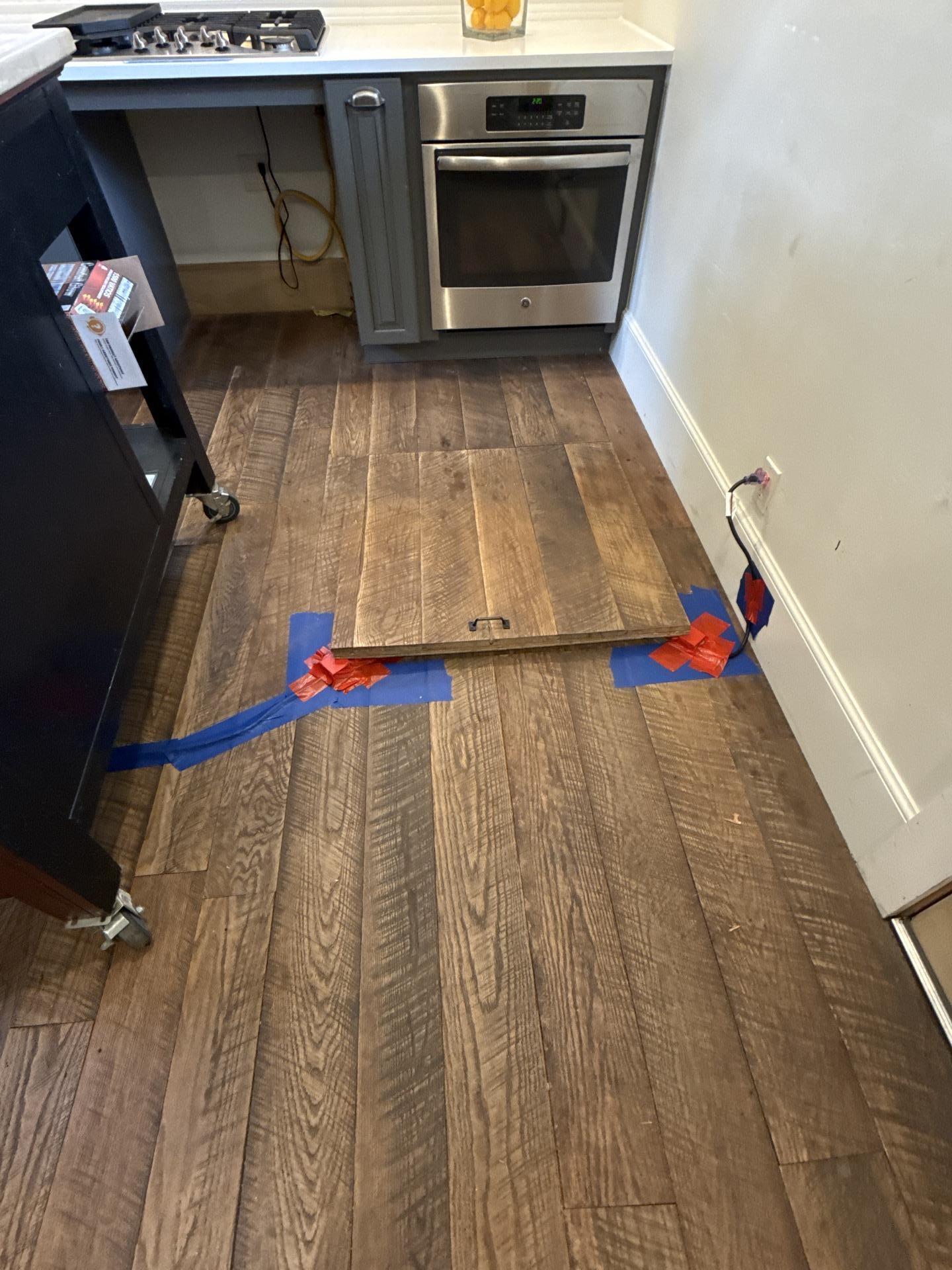 Damp crawlspace under a Marble CO kitchen showing moisture and suspected mold growth before remediation