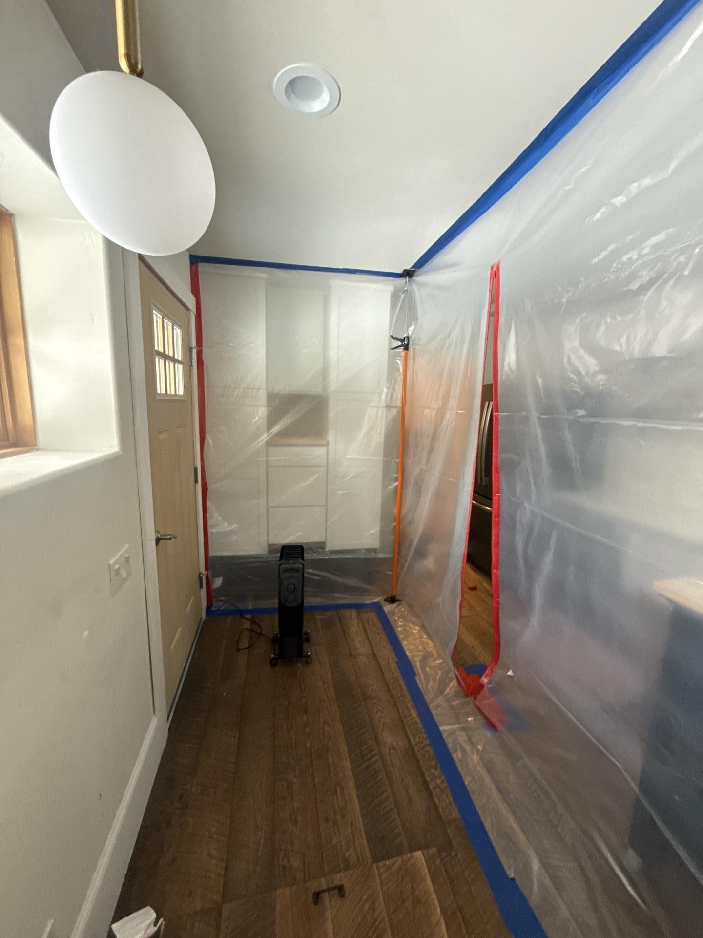 Containment setup at a kitchen crawlspace entry during mold remediation in Marble Colorado