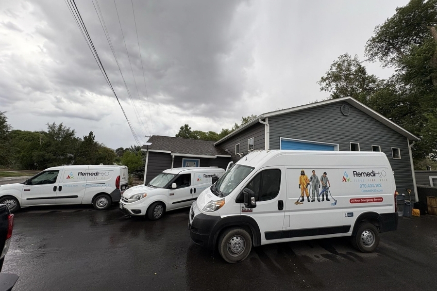 RemediH2O trucks parked in front of a home during a water damage restoration project