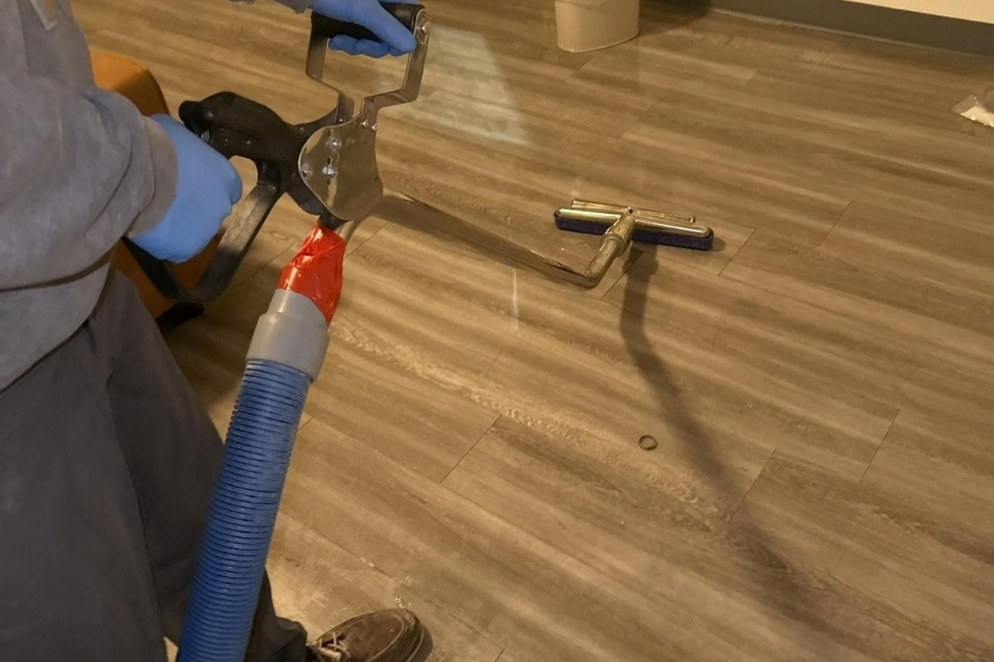 Water damage restoration crew extracting standing water from a home's flooring in Glenwood Springs